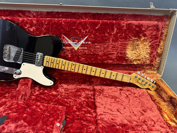 Black Fender Custom Shop Telecaster electric guitar with maple neck and pickguard in vintage red plush-lined hard case