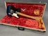 Fender Custom Shop Limited Edition black electric guitar with maple neck and vintage white pickguard in beige hardshell case with red velvet interior lining.