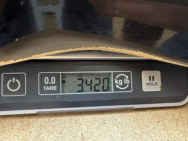 Close-up of digital scale showing 3.420 kilograms weight of a guitar body piece with worn edge, displayed for Coffee House Guitars product listing.