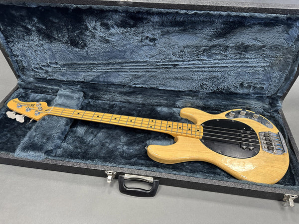 Vintage natural finish Music Man StingRay bass guitar with maple neck and black pickguard in open plush blue-lined hard case