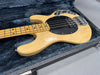 Vintage natural finish electric bass guitar with black pickguard in open hard case with plush interior