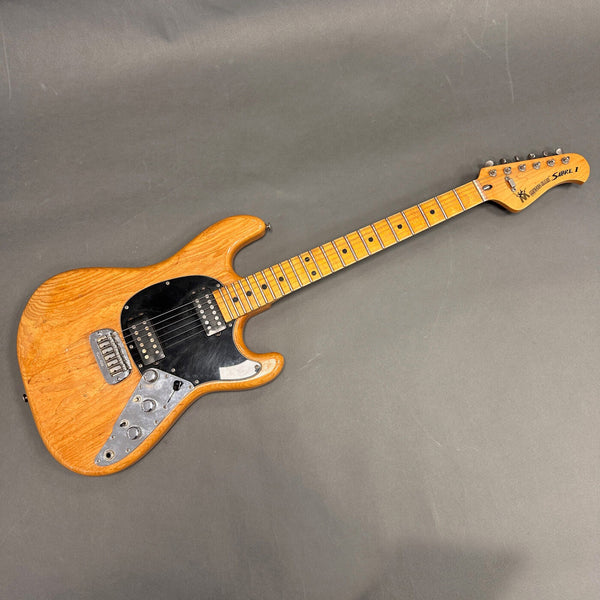 Vintage natural finish Guild Sabre I electric guitar with maple neck and black pickguard on gray background