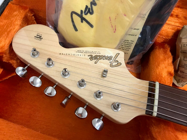 Fender Stratocaster electric guitar maple headstock with chrome tuning pegs in orange plush case with Fender cloth and accessories
