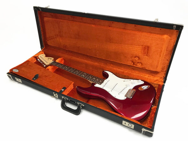 Fender Stratocaster electric guitar in candy apple red finish with white pickguard inside vintage orange plush-lined hard case