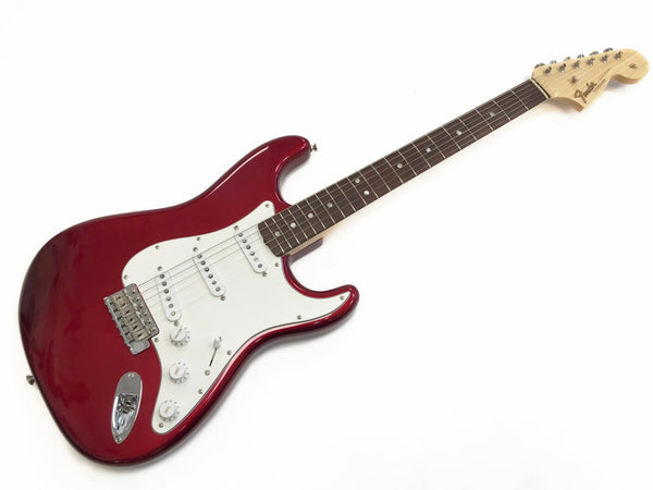 Fender electric guitar with red body, white pickguard, three single-coil pickups, maple neck, and rosewood fretboard on white background