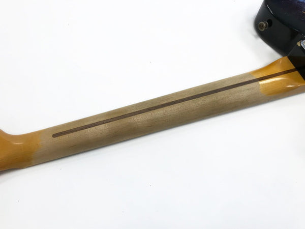 Maple guitar neck with skunk stripe wood reinforcement on a white background