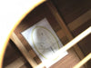 Close-up view of Taylor Guitars model 210 label inside acoustic guitar body with wooden bracing visible