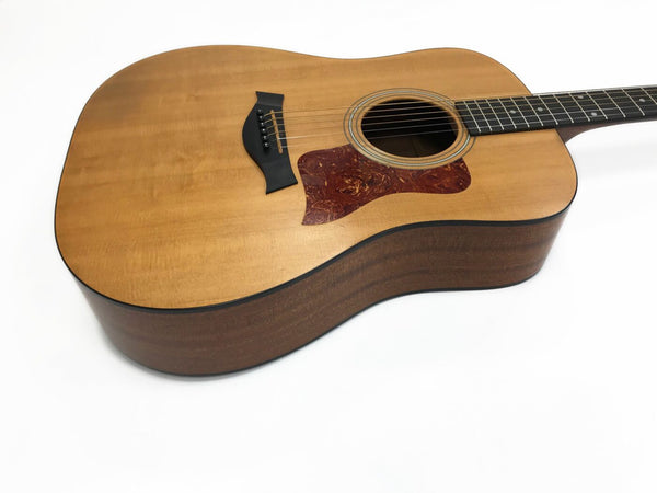 Acoustic guitar with natural wood top and dark wood sides and back on white background