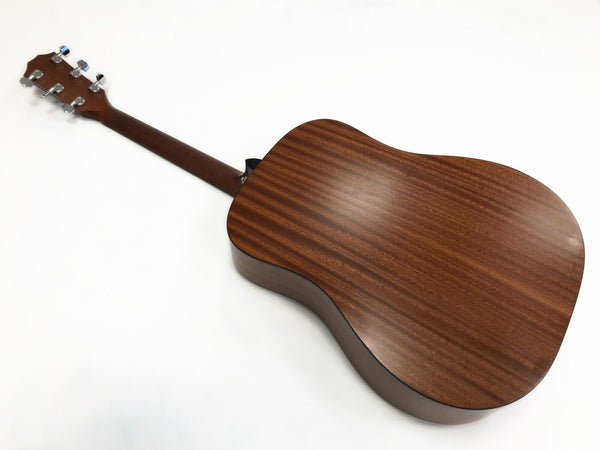 Back view of acoustic guitar with mahogany wood finish and chrome tuning pegs on white background
