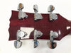 Close-up of red guitar headstock with six chrome Yamaha tuning pegs and "Made in Japan" stamped on the back