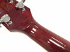 Close-up of glossy red guitar neck and headstock with chrome tuning pegs on white background