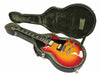 Sunburst electric guitar with dual humbucker pickups in open black hard case with green plush interior lining