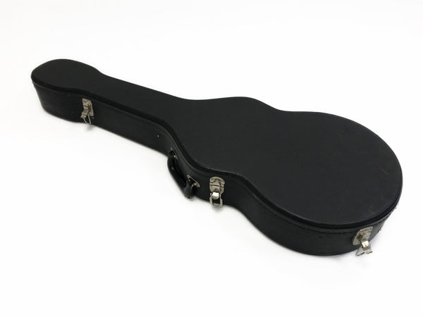 Black hard shell guitar case with metal clasps and handle on white background, protective storage for acoustic guitars