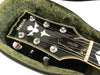Close-up of Yamaha SG700 guitar headstock with tuning pegs and decorative inlay inside green plush guitar case lining